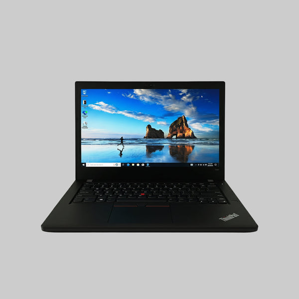 Black laptop on a white surface with a scenic wallpaper