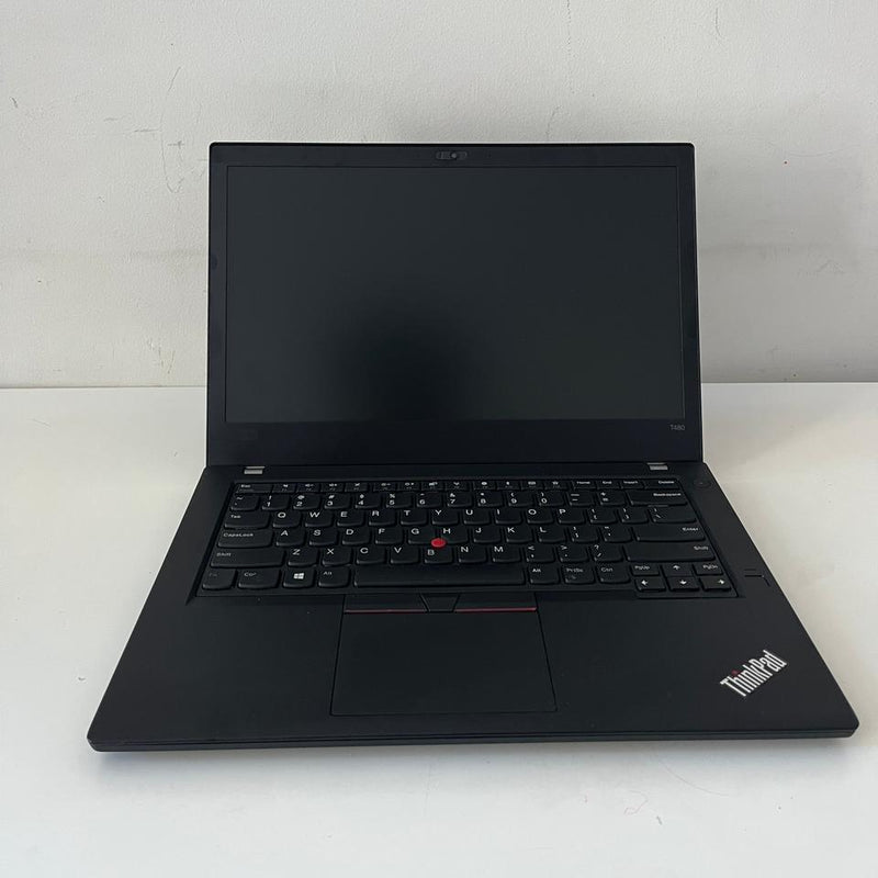 Black laptop on a white surface with a scenic wallpaper