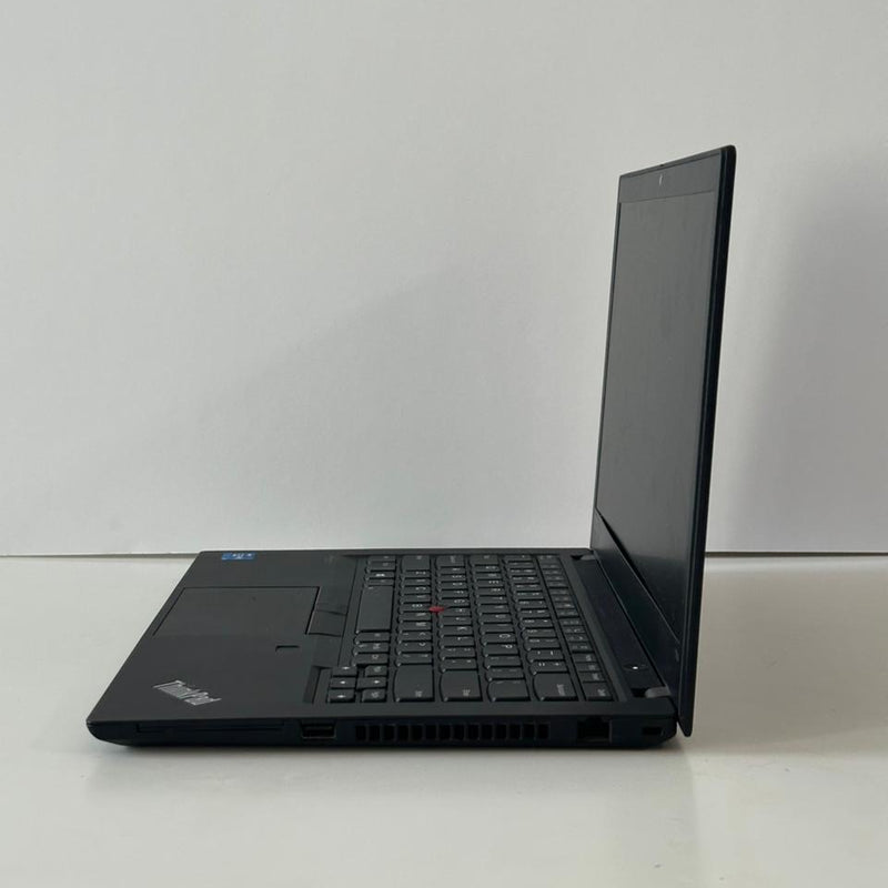 Black laptop on a white surface with a white background