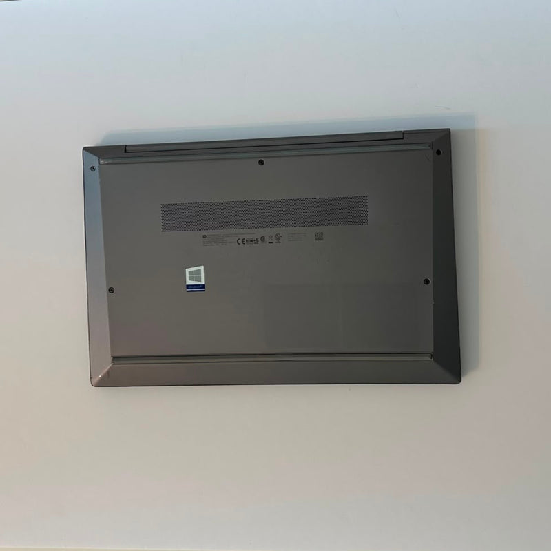An open black HP laptop on a plain white background, displaying a medical monitoring software interface on the screen.