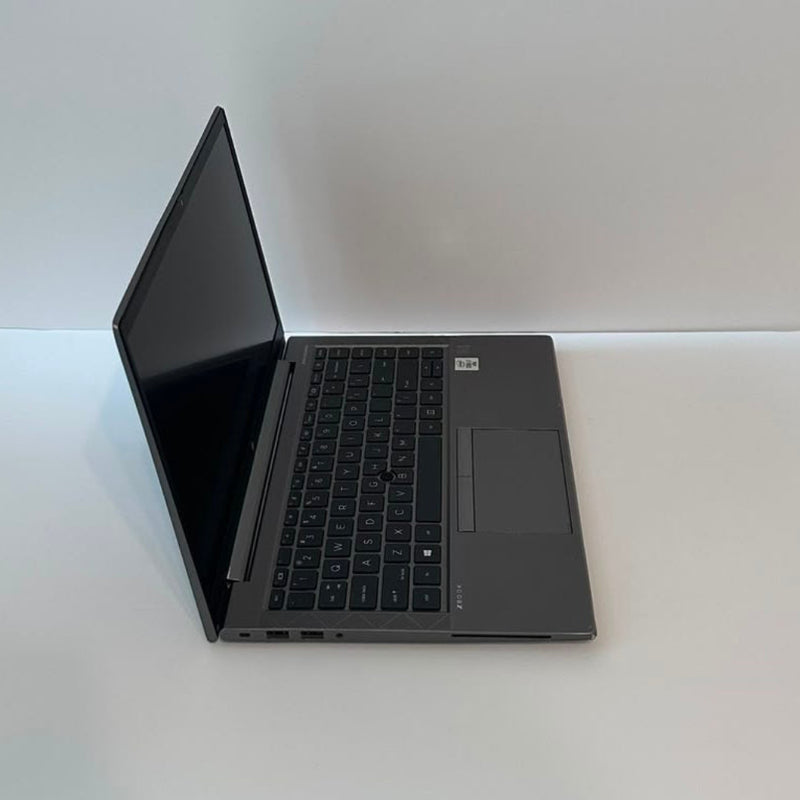 An open black HP laptop on a plain white background, displaying a medical monitoring software interface on the screen.