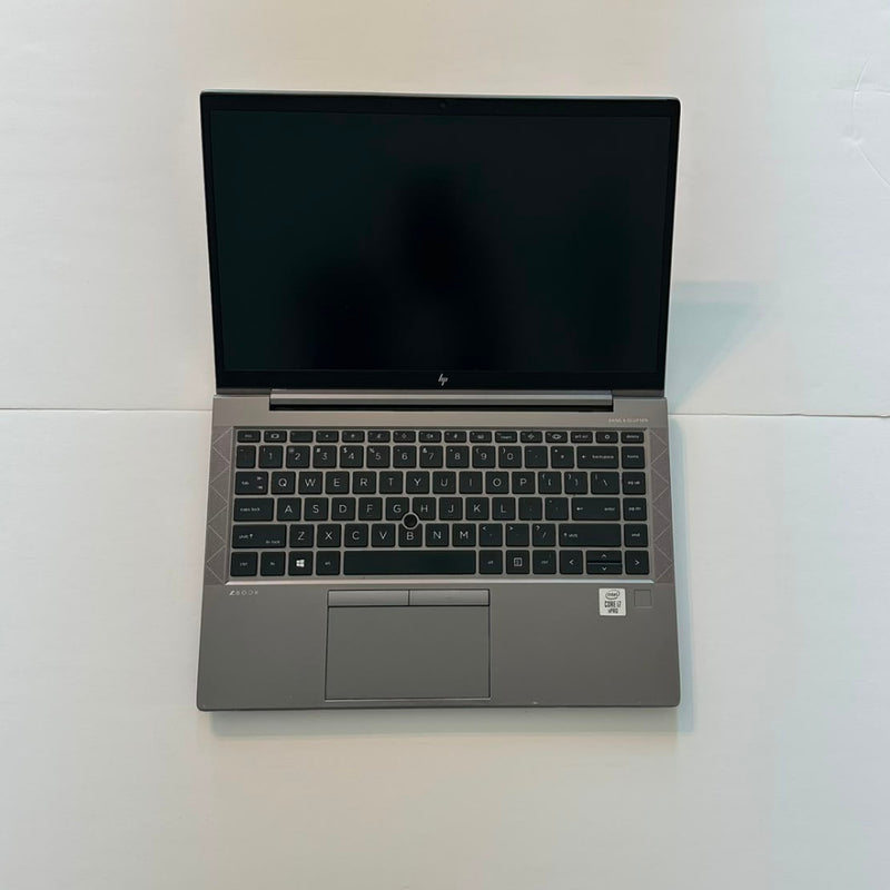 An open black HP laptop on a plain white background, displaying a medical monitoring software interface on the screen.