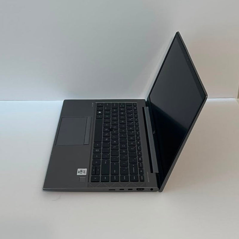 An open black HP laptop on a plain white background, displaying a medical monitoring software interface on the screen.